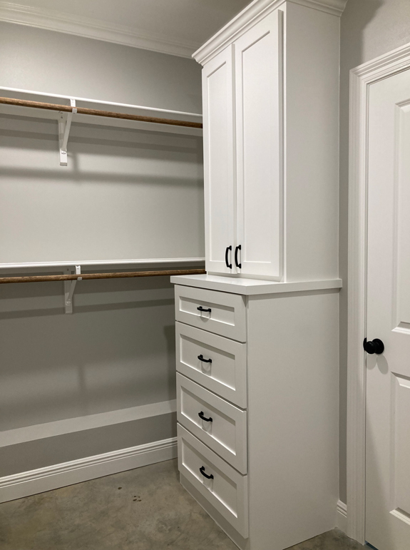 Master walk-in closet with built in cabinetry. 