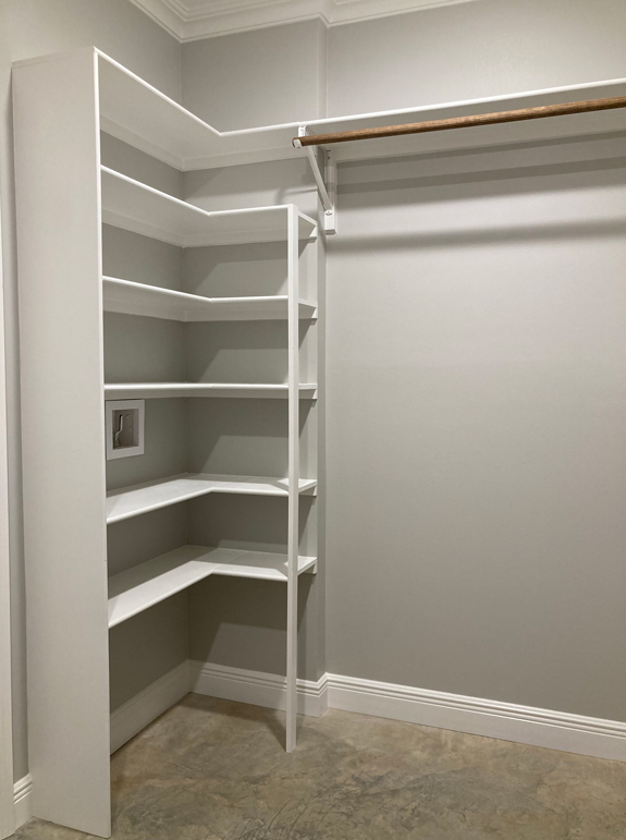 Master walk-in closet with built in shelves.