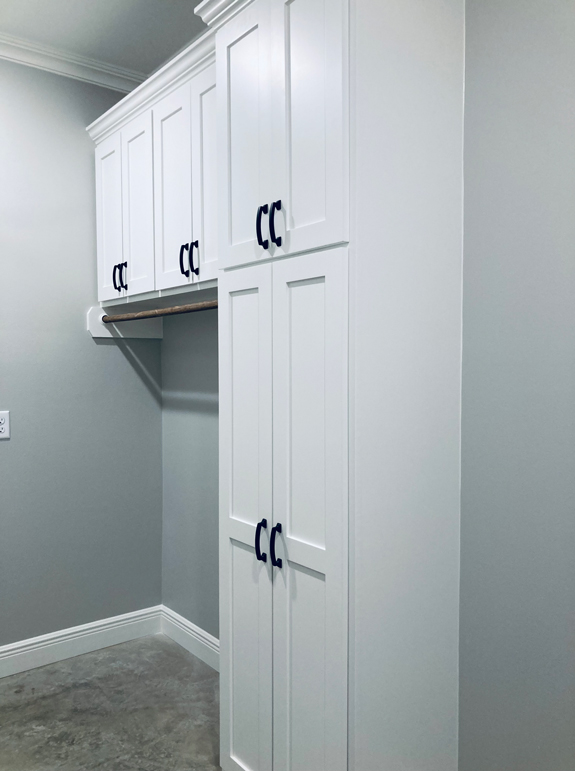 Utility room with built-in cabinetry.